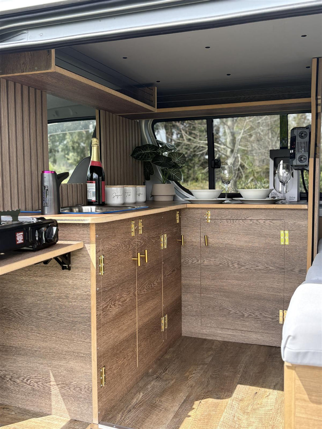 Campervan interior with timber cabinetry and sink