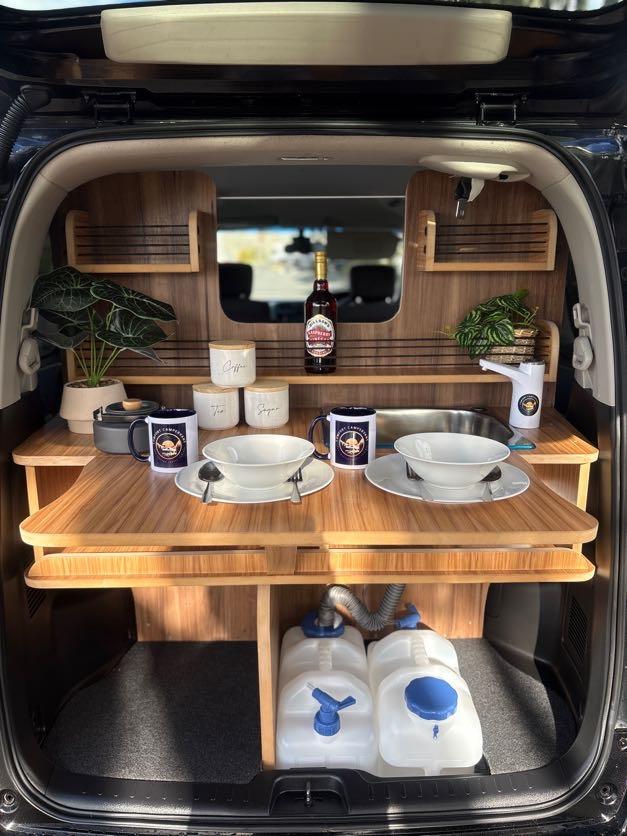 Serena campervan rear kitchen with sink, cooker and mugs