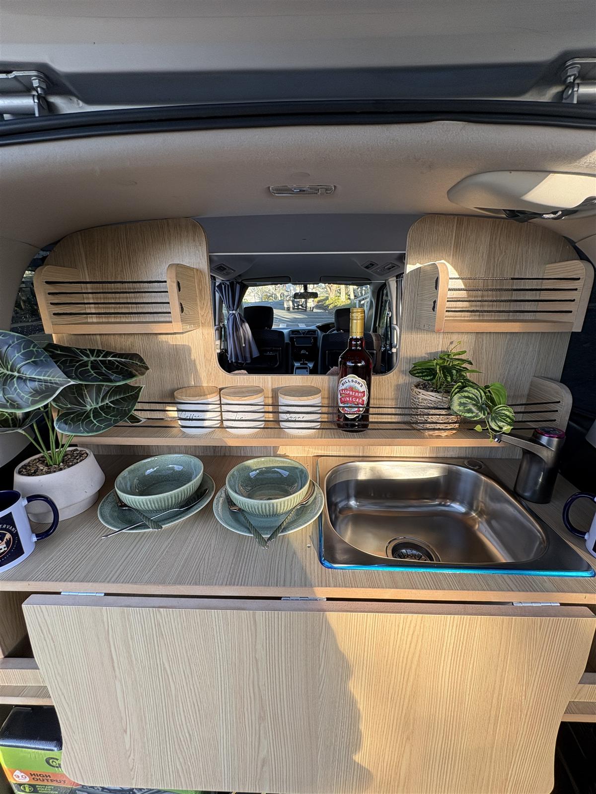 Nissan Serena campervan rear kitchen with sink and shelving